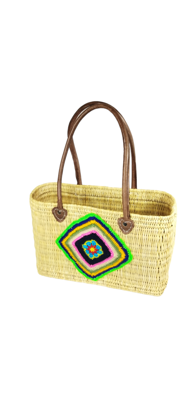Straw basket decorated with a piece of colorful cotton